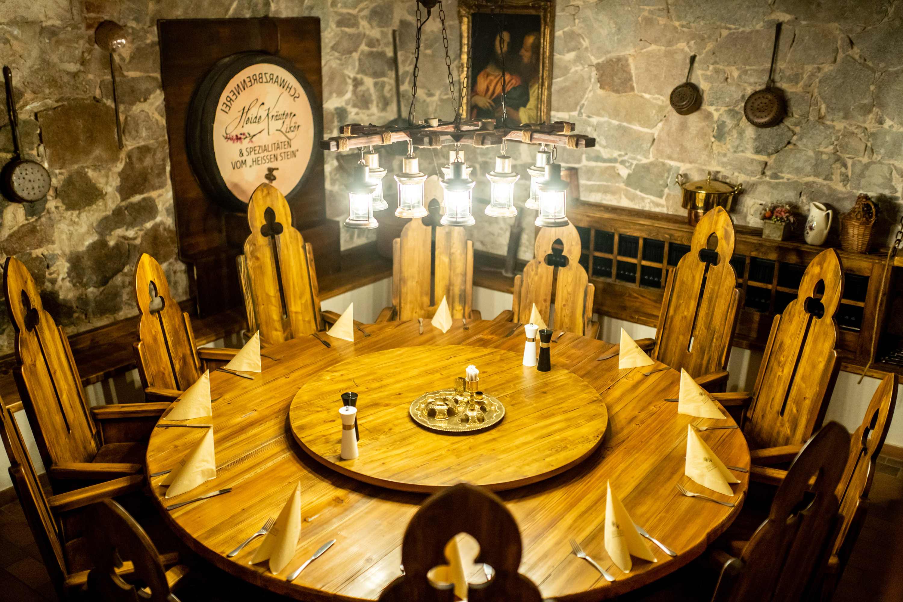 Rustic round dining table in cellar vault